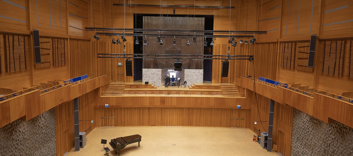 A concert hall with an organ and a grand piano