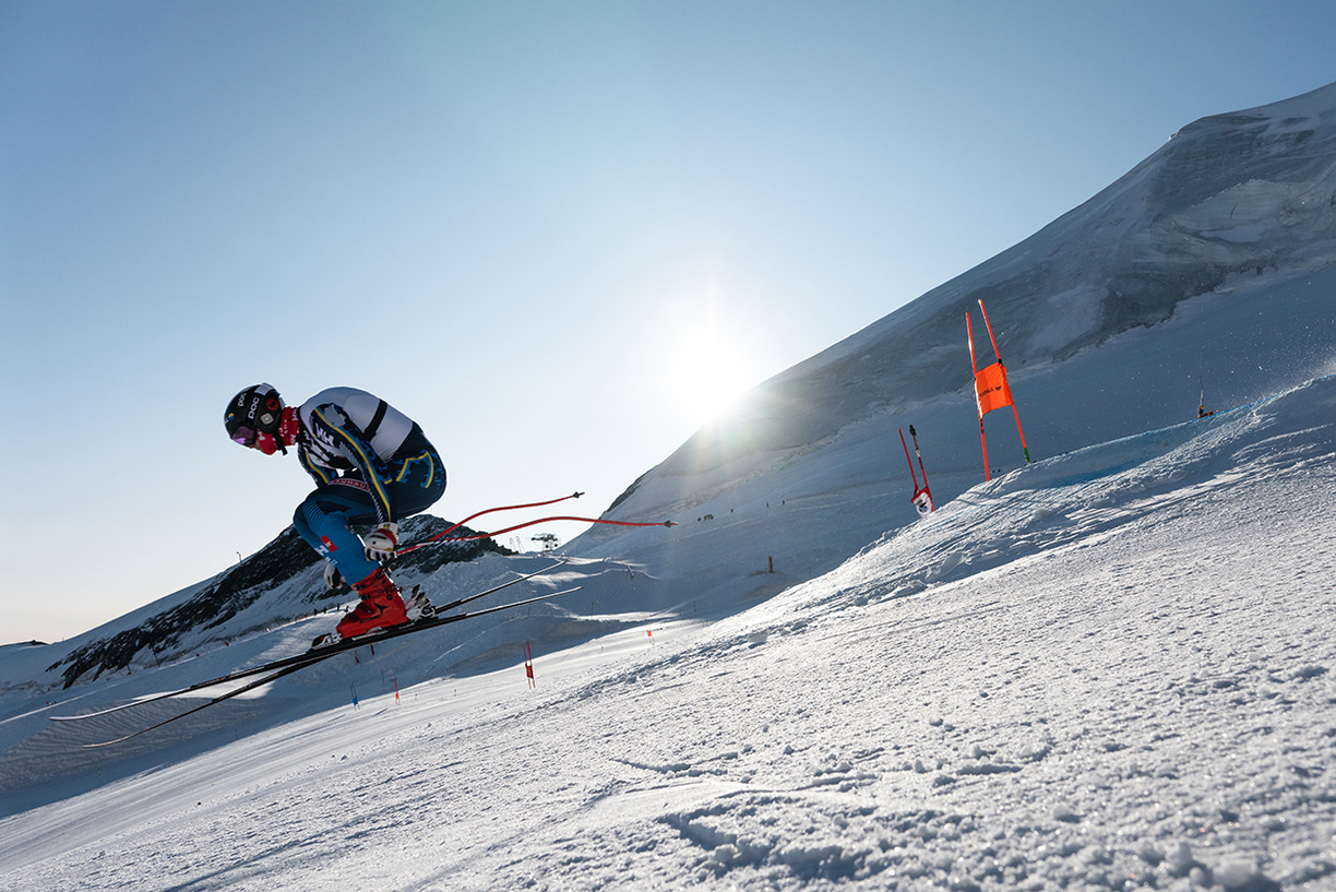 Skier in the middle of a jump on a ski slope