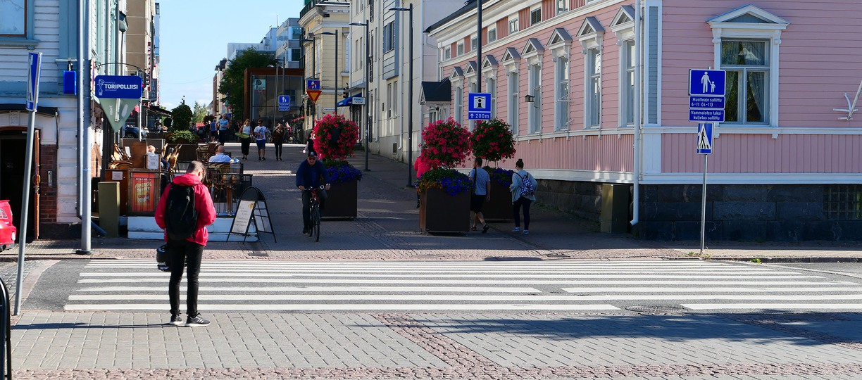Person crossing street in town.